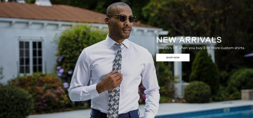 Male model wearing a white button down shirt and tie standing outside next to a pool. Click to shop Ledbury's new arrivals for summer. 