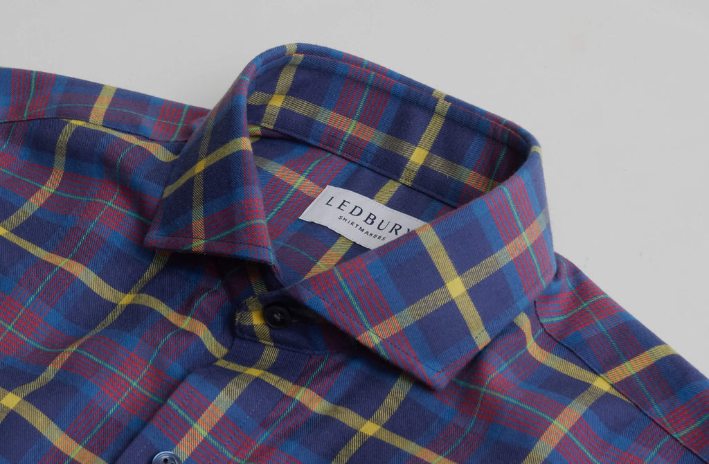 Closeup of the collar of a men's blue, purple, yellow and red flannel by Ledbury