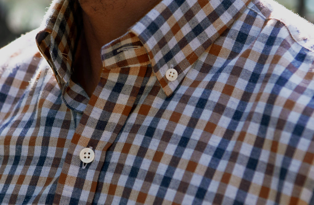 Closeup of the collar of a men's brown and navy button down lightweight flannel from Ledbury