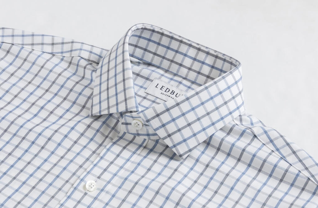 Closeup of the collar of a men's blue and grey check dress shirt by Ledbury